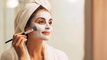 A woman with a white towel on her head and a face mask photo
