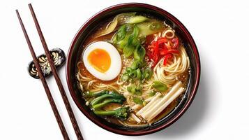 A bowl of ramen with an egg and chopsticks photo