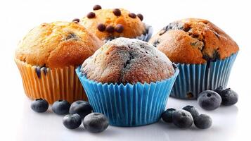A group of muffins with blueberries on a white surface photo