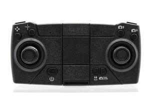 A full shot of a black drone controller, showcasing its compact design and various controls. photo