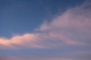 pink clouds in the blue sky. Beautiful sky on makat during the warm season. photo