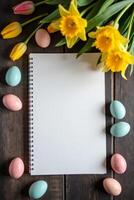 Spiral notebook with empty pages placed on rustic wooden table, surrounded by pastel Easter eggs and spring flowers, symbolizing Easter planning Space for text photo