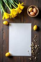 Yellow daffodils, decorated eggs in basket, and blank paper on dark wooden background. Springtime and Easter celebration concept photo