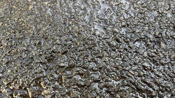 wet asphalt road seen from close up looks shiny photo