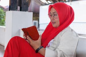 Woman using digital tablet for online reading in a casual setting photo