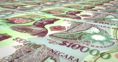 Series of banknotes of one thousand ringgits or bruneian dollars of the bank of the sultanate of Brunei Darussalam rolling on screen, coins of the world, cash money, loop video