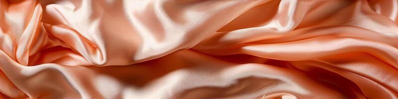 The banner texture of draped fabric of peach color. Beautiful emerald peach fuzz soft silk textile. Design for texture, background, wallpaper. photo
