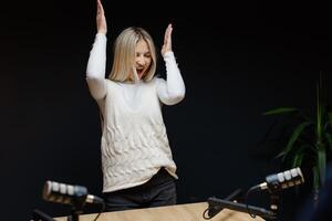 Podcaster dancing and laughing during a recording session photo