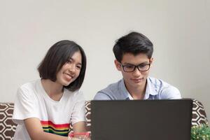 Lovers Fun and smiling with home working, learn and plan e-commerce work with his small business. Gen Z business people. photo