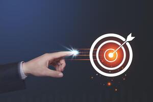 Human hand touching glowing point at target circle with light effects on dark blue background. Business goal setting concepts Mosquito nets focus on the core of an important destination.copy space. photo