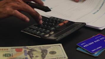 a man is calculating his company's income using a calculator. business and financial concepts video