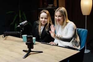 Two Content Creators Waving at Camera During Live Podcast Recording photo
