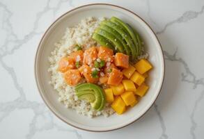 Plate of poke bowl rice salmon avocado mango. photo