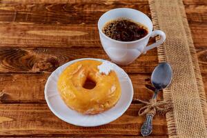 Colorful Donuts breakfast composition with different color styles of doughnuts over an aged wooden desk background. photo