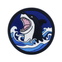 A This features circular embroidered patch design of shark with its mouth open, surrounded by stylized ocean waves. background is deep blue, enhancing dynamic and bold appearance of shark png