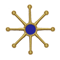 A golden embroidered starburst design with central blue circle and radiating lines on transparent background. intricate pattern is symmetrical and decorative png