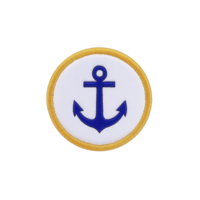 A round embroidered patch features blue anchor design on transparency background, bordered by yellow edge. nautical theme evokes sense of adventure and maritime tradition png