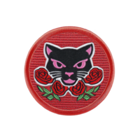 A round embroidered patch features fierce black panther head with pink eyes and pink nose, surrounded by vibrant red roses on red background. design is bold and striking png