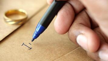 Writing a heartfelt message on a brown envelope with a blue pen video