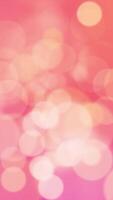 Vibrant bokeh background animation with gently flickering defocused bokeh light spheres on a warm pink orange color gradient. This cheerful vertical background is full HD and a seamless loop. video