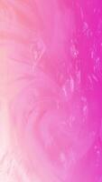Abstract liquid effect background with soft flowing ripping waves and swirls on a warm pink color gradient. Smooth fluid motion creates a serene calming atmosphere. Vertical animation. video