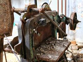 Rusted industrial equipment showing severe decay and corrosion inside an abandoned factory site photo