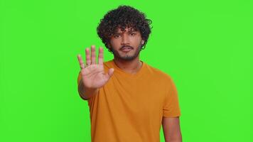 Indian man say No hold palm folded crossed hands in stop gesture warning of finish prohibited access video