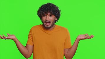 Puzzled clueless uncertain man raising hands in helpless, embarrassed confused by difficult question video
