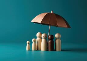 Wooden figures of a family standing under an umbrella, symbolizing protection, insurance, and security on a blue background. Concept for financial safety and support. photo