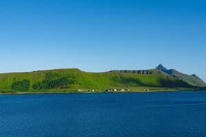 Lofoten Summer Landscape .Lofoten is an archipelago in the county of Nordland, Norway. Is known for a distinctive scenery with dramatic mountains and peaks, sea and ocean. photo