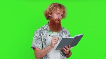 Man making notes writing down thoughts with pen into notepad notebook diary, to do list, good idea video