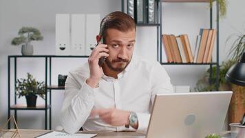 Young business man showing smartphone asking to make telephone conversation gesturing call me sign video