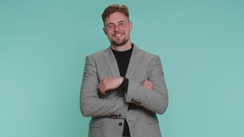 Cheerful happy young business man smiling, looking at camera, celebrating success, winning good news video