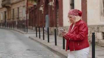 Tourist traveler senior woman using looking smartphone search a way on map in mobile navigator app video