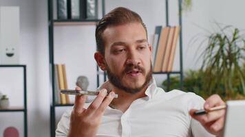 Lebanese business man working having mobile phone talk at office workplace using messenger chat apps video