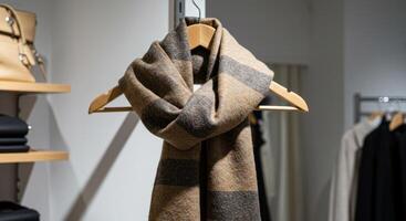 Elegant wool scarf on a hanger in a minimalistic boutique setting photo