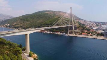 Drone shot of Franjo Tudman Bridge, a cable-stayed bridge, engineering work built for transportation and travel, near the port of Dubrovnik in Croatia video
