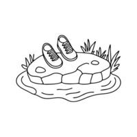 A pair of shoes resting on a flat rock beside a stream vector