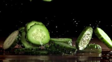 Sliced cucumbers fall on the table. Filmed on a high-speed camera at 1000 fps. High quality FullHD footage video