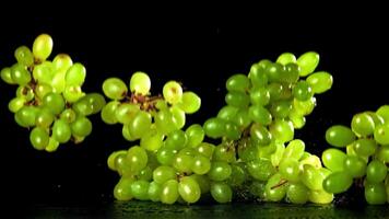 Green grapes fall on the table. Filmed on a high-speed camera at 1000 fps. High quality FullHD footage video