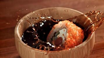 The Japanese roll falls into the soy sauce. Filmed on a high-speed camera at 1000 fps. High quality FullHD footage video