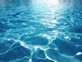 Rippling clear waters create intricate patterns under sunlight, casting reflections and shimmering blue hues. The serene scene evokes tranquility and natural beauty photo
