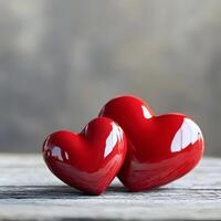 Two Shiny Red Hearts on Rustic Wooden Surface photo