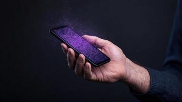 A person holding a smartphone with purple light coming out of it photo