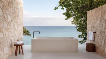 A bathtub sitting in a room overlooking the ocean photo