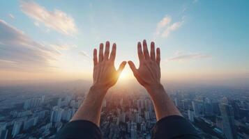 Hands reaching up to the sun over a city photo