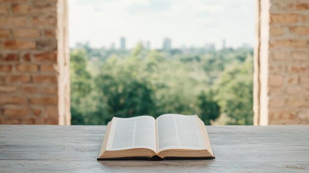 An open bible on a wooden table in front of a window with a city view photo