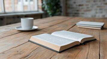 An open book and coffee cup on a wooden table photo