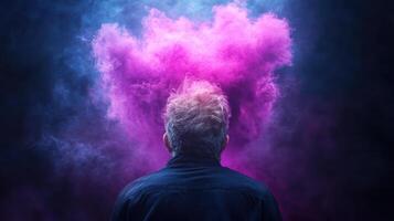 A man is looking at a cloud of pink smoke photo