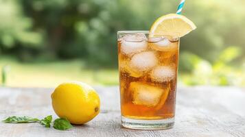 A glass of iced tea with lemon and mint photo